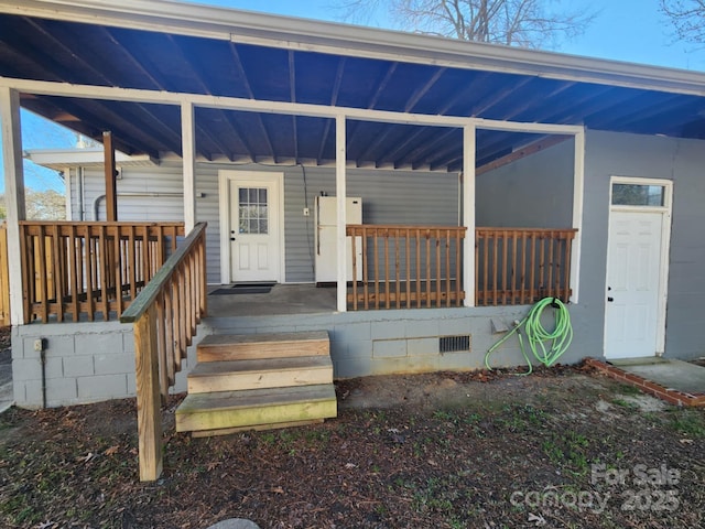 doorway to property featuring a porch