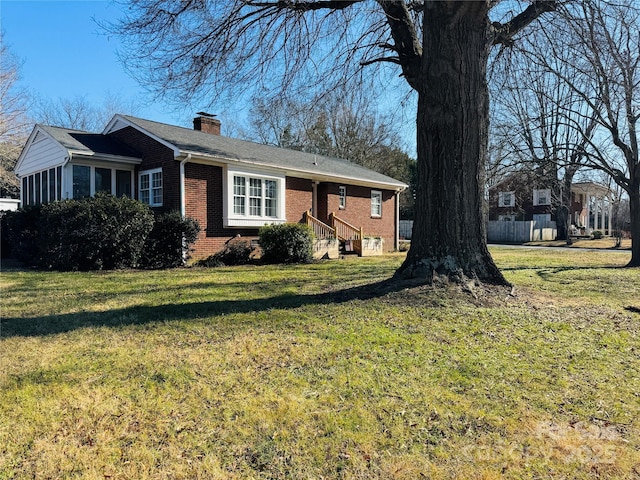 813 S Zion St, Landis, NC 28088 - single story home featuring brick siding, a chimney, a front lawn, and a sunroom