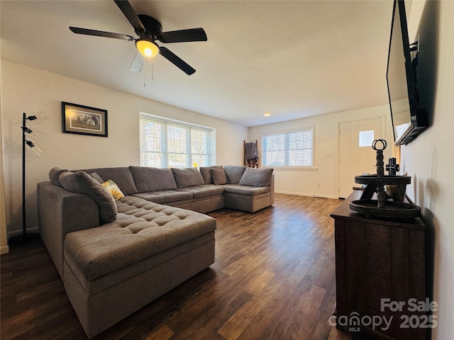 living room featuring ceiling fan and dark hardwood / wood-style flooring