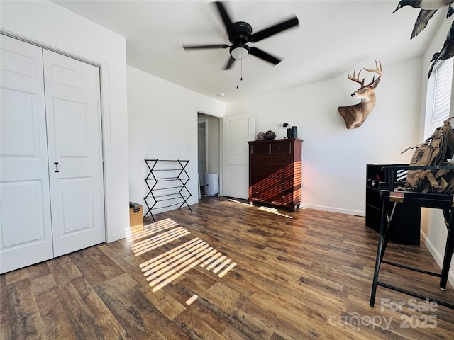 bedroom featuring ceiling fan, dark wood-type flooring, and a closet