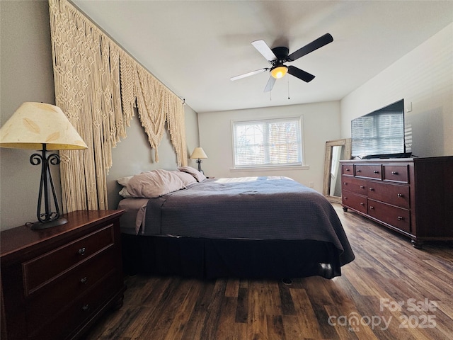 bedroom with ceiling fan and dark hardwood / wood-style flooring