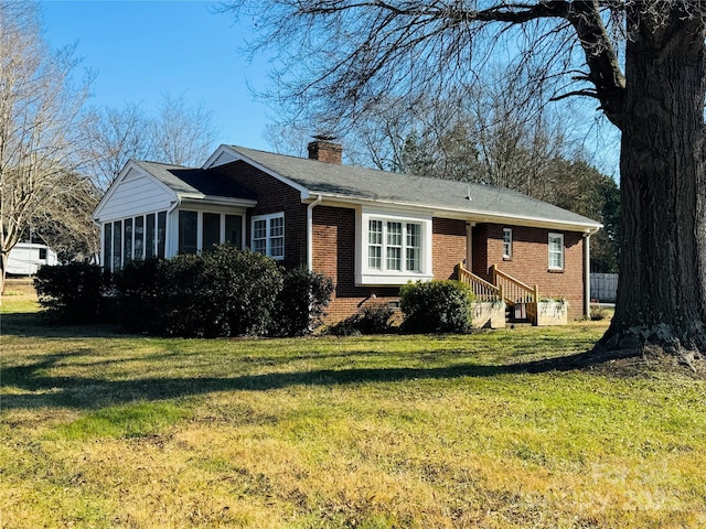 ranch-style home with a front lawn and a sunroom