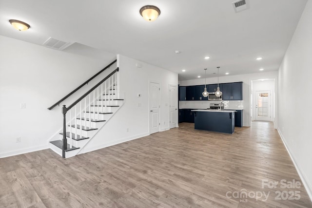 unfurnished living room with hardwood / wood-style flooring