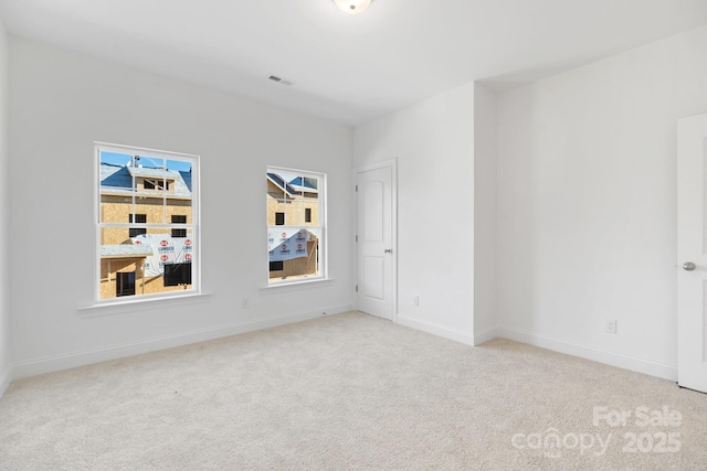 empty room featuring light carpet