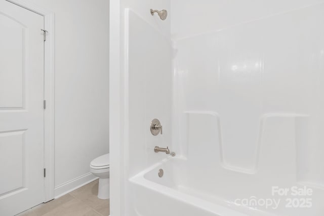 bathroom with tile patterned flooring,  shower combination, and toilet