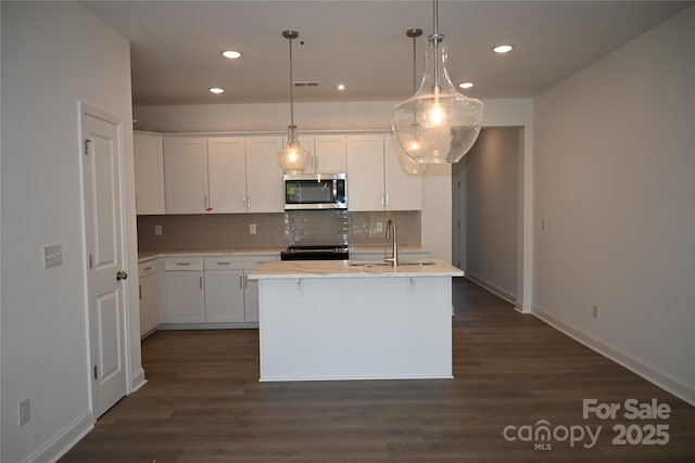 kitchen with decorative backsplash, stainless steel appliances, a sink, and recessed lighting