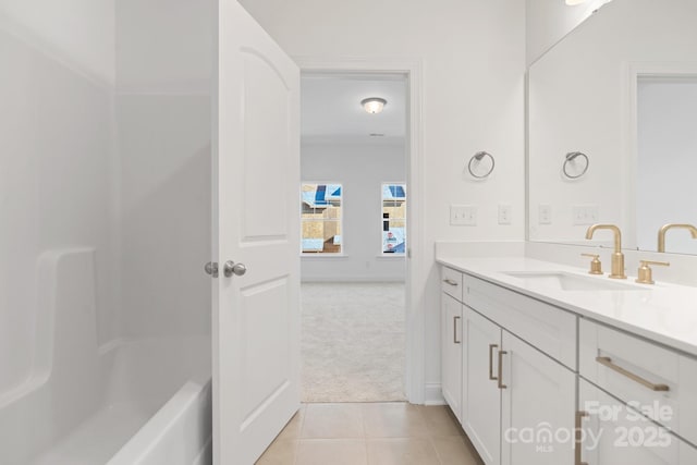 full bath with baseboards, vanity, and tile patterned flooring