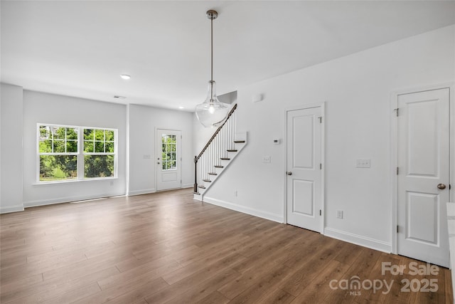 143 Cherry Springs Ln Unit 13-C, Asheville, NC 28804 - unfurnished living room featuring stairs, wood finished floors, and recessed lighting