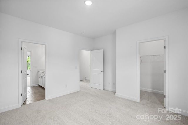 143 Cherry Springs Ln Unit 13-C, Asheville, NC 28804 - unfurnished bedroom with carpet, a walk in closet, connected bathroom, and a closet