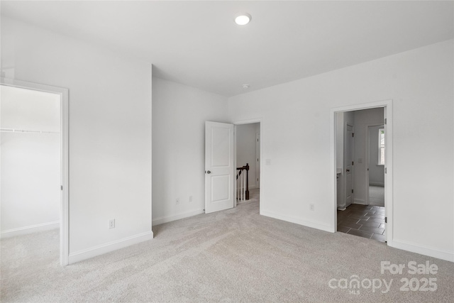 143 Cherry Springs Ln Unit 13-C, Asheville, NC 28804 - unfurnished bedroom with a spacious closet, carpet, a closet, and connected bathroom