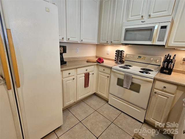 kitchen featuring white appliances and light tile patterned flooring