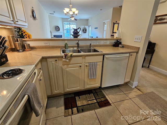 kitchen with dishwasher, sink, hanging light fixtures, white electric range, and an inviting chandelier