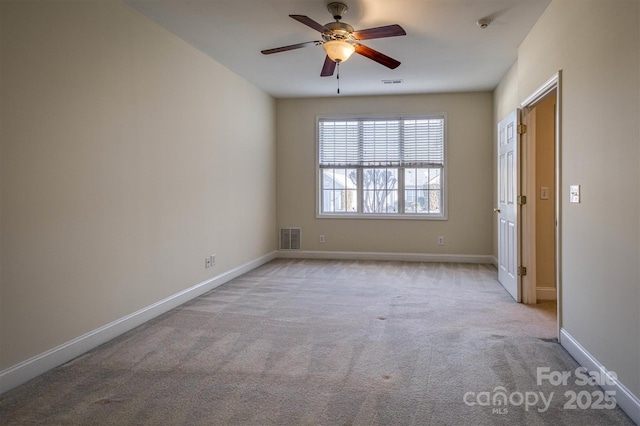 empty room with light colored carpet and ceiling fan