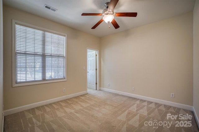 carpeted empty room featuring ceiling fan