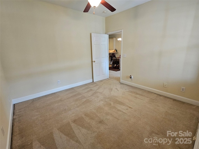 spare room with light carpet and ceiling fan