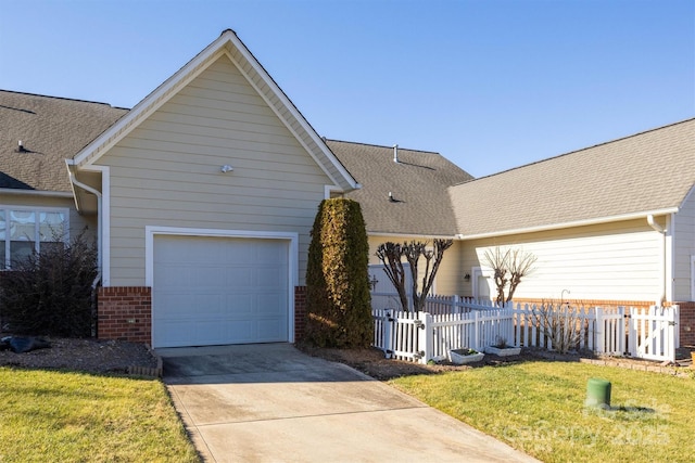 view of front of property with a garage and a front yard