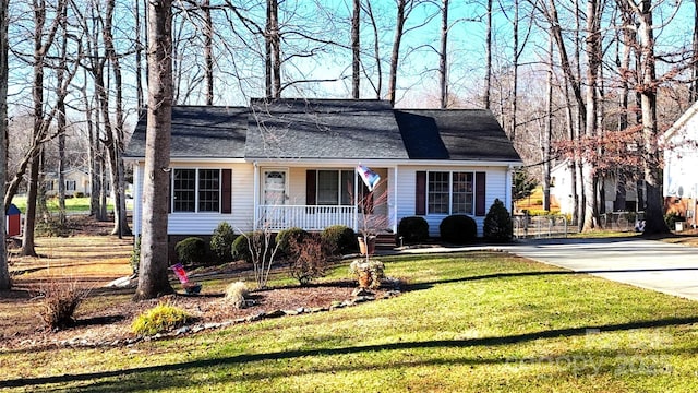 single story home with covered porch and a front yard