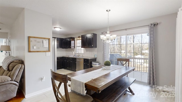 dining area with an inviting chandelier and sink