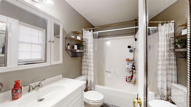 full bathroom with shower / tub combo with curtain, vanity, a textured ceiling, and toilet