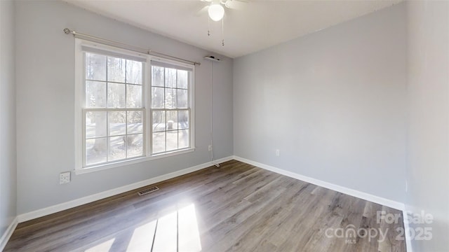 spare room featuring ceiling fan and hardwood / wood-style floors