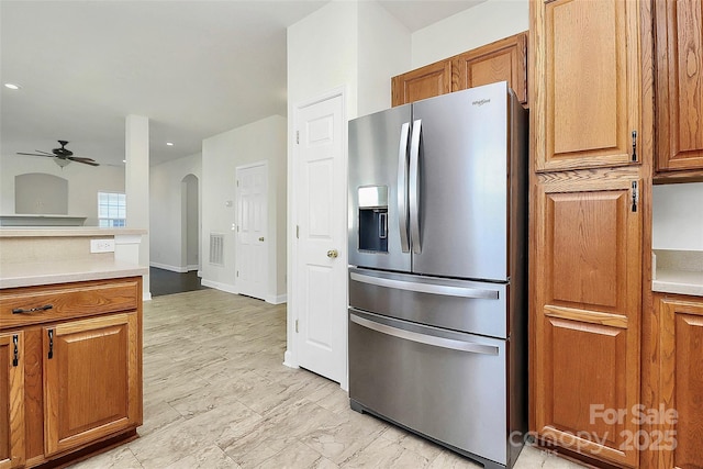 kitchen featuring stainless steel fridge with ice dispenser and ceiling fan