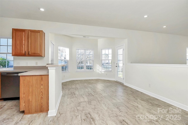 kitchen featuring dishwasher, light hardwood / wood-style floors, and kitchen peninsula