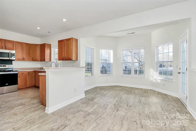 kitchen featuring a wealth of natural light and stainless steel appliances