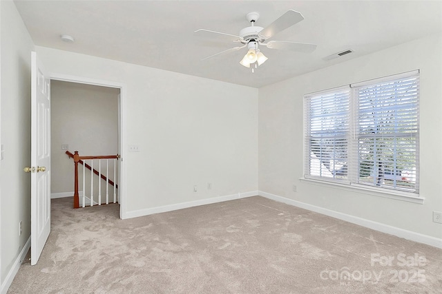 carpeted spare room with ceiling fan