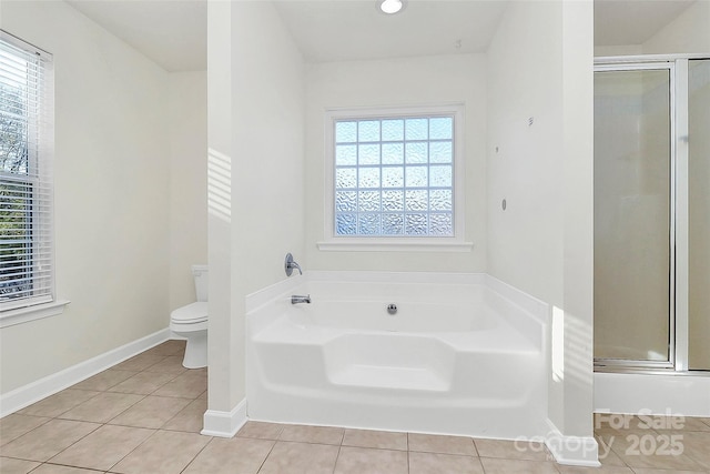 bathroom featuring toilet, shower with separate bathtub, and tile patterned floors