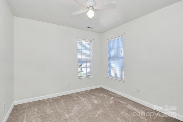 empty room with ceiling fan and carpet