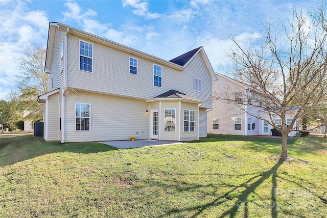 rear view of house with a patio area and a yard