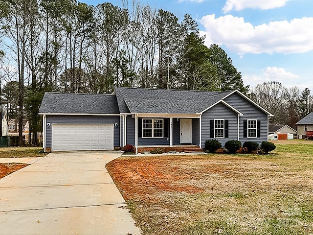 ranch-style house featuring a garage, covered porch, and a front yard