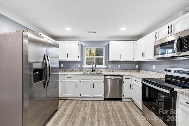 kitchen with white cabinetry, sink, and stainless steel appliances