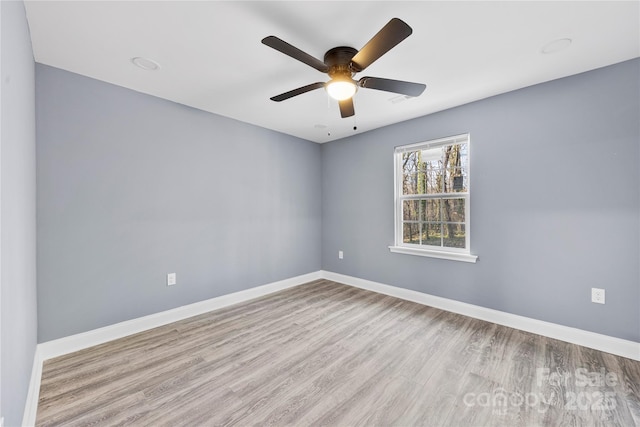 spare room featuring ceiling fan and light hardwood / wood-style flooring