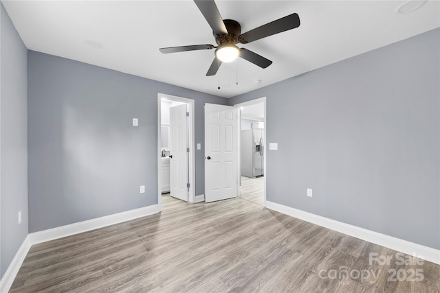 unfurnished bedroom featuring stainless steel refrigerator with ice dispenser, light hardwood / wood-style floors, and ceiling fan