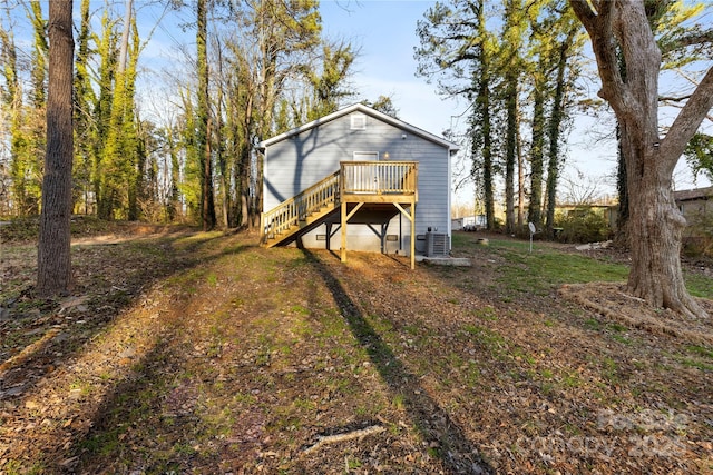 rear view of house featuring central AC unit and a deck