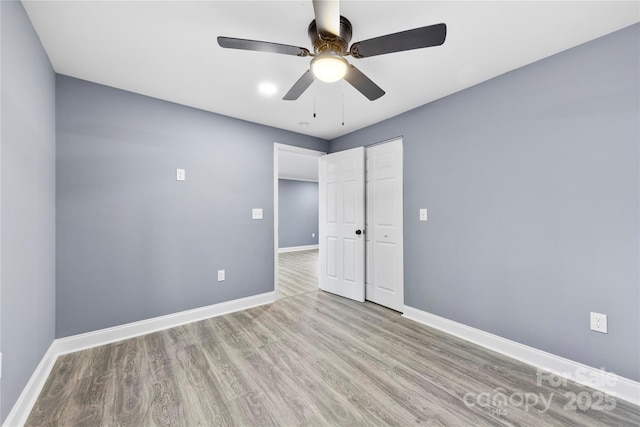 unfurnished bedroom with a closet, ceiling fan, and light hardwood / wood-style flooring