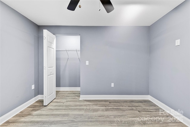 unfurnished bedroom featuring light wood-type flooring, a closet, and ceiling fan