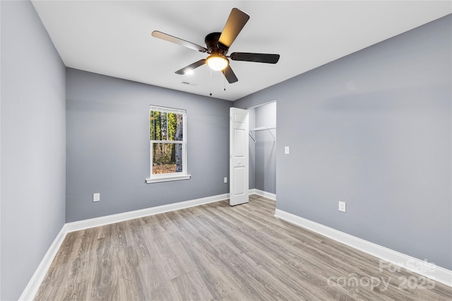 unfurnished bedroom with ceiling fan, light hardwood / wood-style floors, and a closet