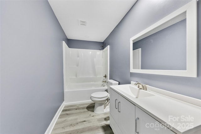 full bathroom with vanity, wood-type flooring,  shower combination, and toilet