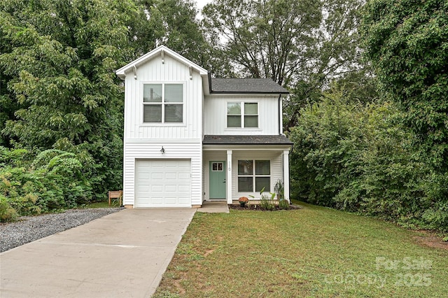 view of front of property with a front yard and a garage