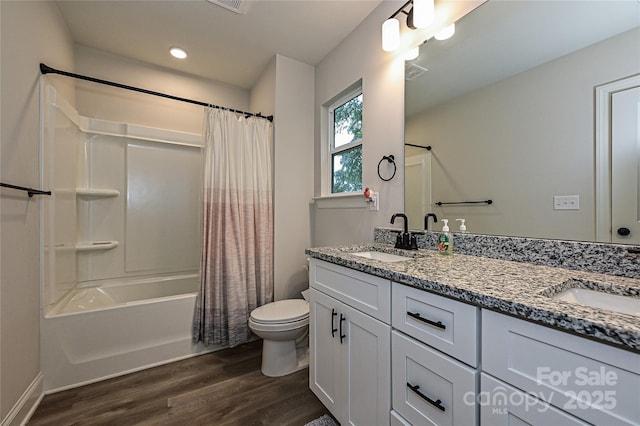 full bathroom featuring shower / bath combination with curtain, vanity, hardwood / wood-style flooring, and toilet