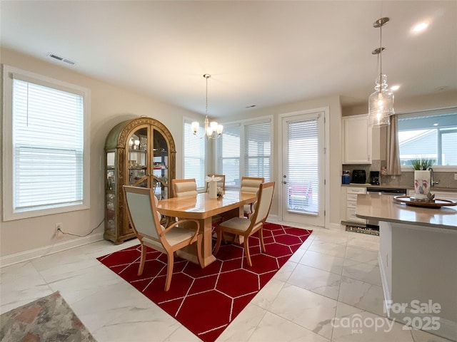 dining space featuring a chandelier