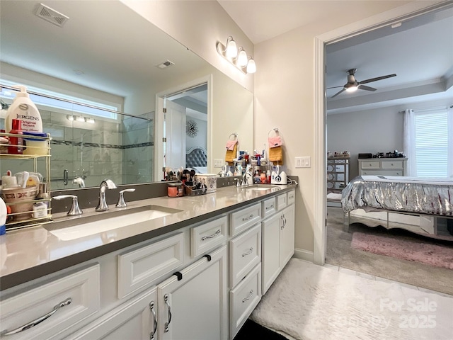 bathroom with ceiling fan, a shower with door, and vanity