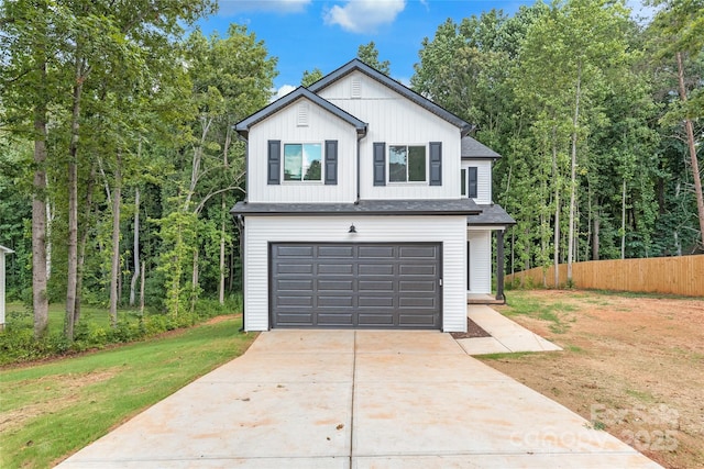 view of front of home featuring a garage and a front lawn