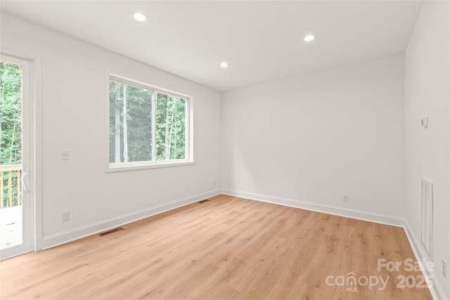 unfurnished room with light wood-type flooring