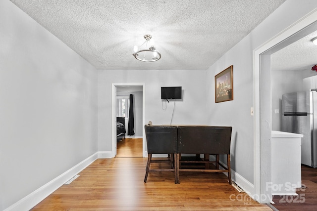 interior space with hardwood / wood-style flooring and a textured ceiling