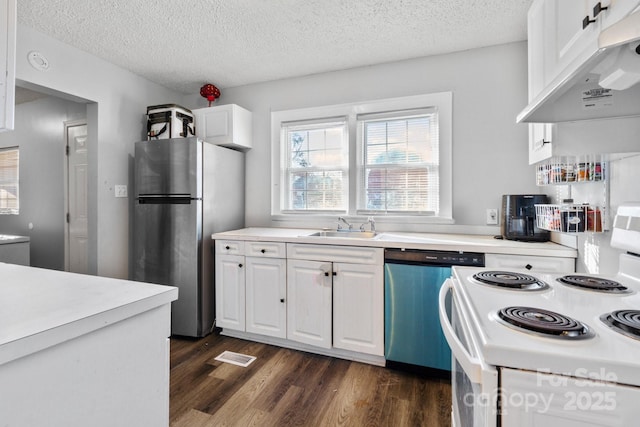 kitchen with white cabinets, sink, stainless steel appliances, and a textured ceiling