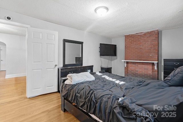 bedroom featuring a textured ceiling and hardwood / wood-style flooring