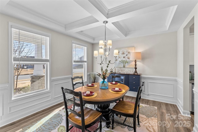 dining area featuring beam ceiling, coffered ceiling, a notable chandelier, crown molding, and hardwood / wood-style floors